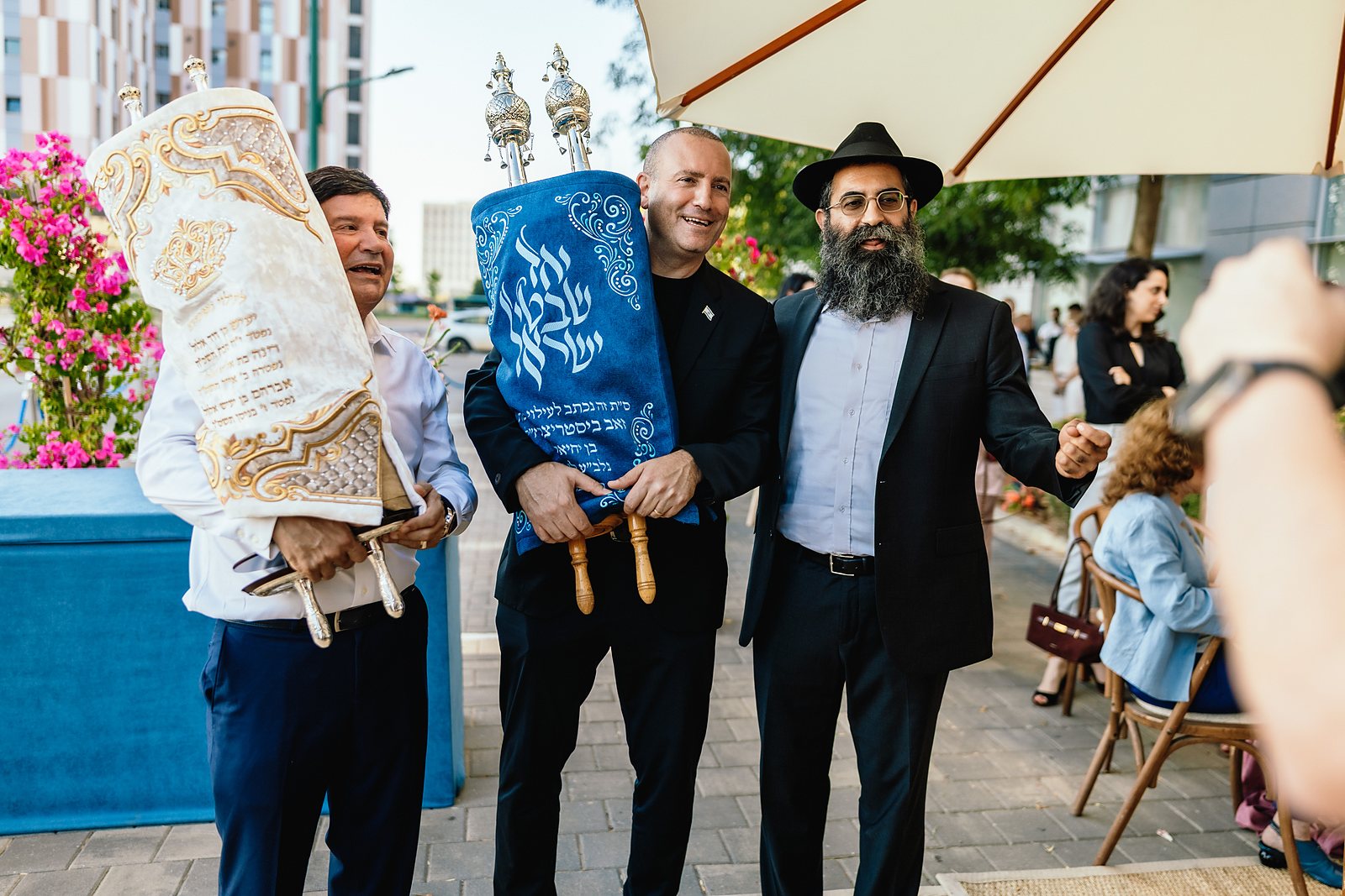 Members of the Peres Academic Center community carrying Torah scrolls together in a procession