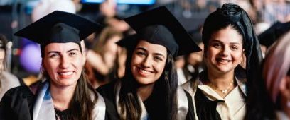 Three women graduates in caps and gowns
